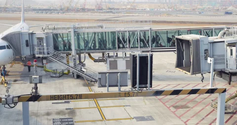 Passengers walking through jet bridge, aircraft boarding time, outside view Stock Footage 309442755