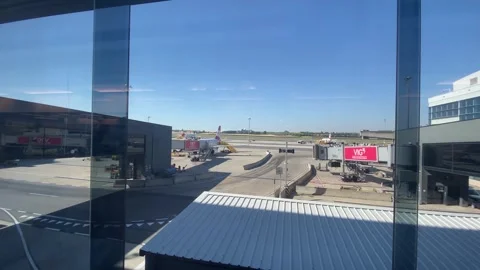 Passengers Walking Through Jet Bridge Tube Vienna Airport VIE - June 27 2026 Stock Footage 337877258