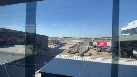 Passengers Walking Through Jet Bridge Tube Vienna Airport VIE - June 27 2026 Stock Footage 337877293