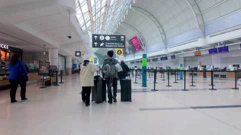 Passengers walking through Toronto Pearson International Airport terminal Stock Footage 320606849