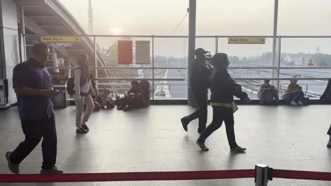 Passengers Walking Through Train Station in Evening Light Stock Footage 343332149