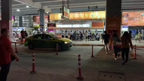 Passengers walking to ticket counters Bangkok bus terminal. Traveller and taxi Stock Footage 189432597
