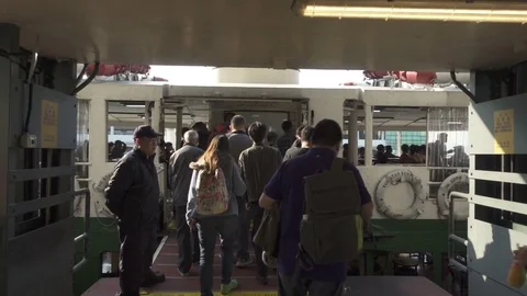Passengers walking towards a Star Ferry at the Central Pier in Hong Kong. Stock Footage 73281420