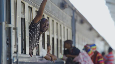 Passengers waving goodbye on the train In A Station.DaresSalaam Tanzania Stock Footage 132290053