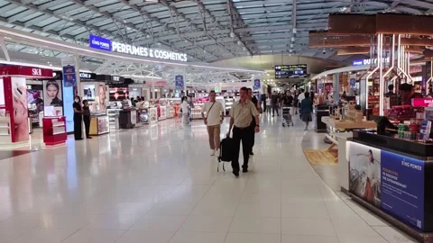 Passengers were walking through the big duty free area to the gates for boarding Stock Footage 289221793