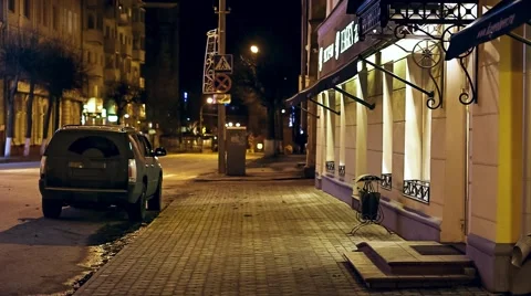 A passer-by a man walks down an empty city street at night Stock Footage 58079671
