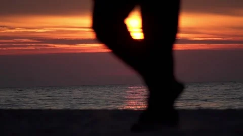 Passerby by the seashore in the setting sun Stock Footage 156882852