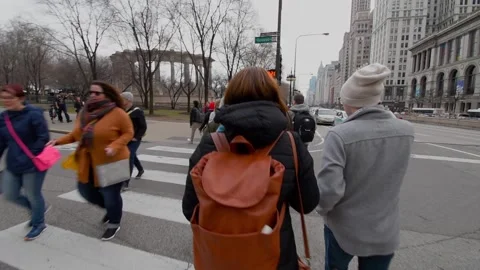 Passersby Crossing the intersection between Randolph Street and Michigan Aven Stock Footage