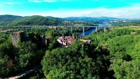 Passes train freccia rossa above bridge near typical Italian village Stock-Footage 229560582
