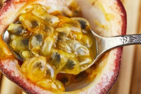 Passiflora close up fruit of fruit with spoon inside on bamboo background Stock Photos