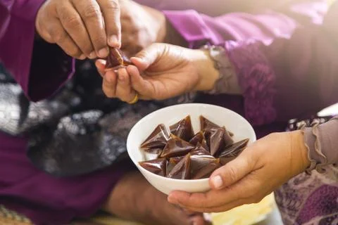 Passing around dodol during Eid Stock Photos