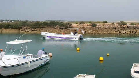 Passing boat creating waves in harbour, Portugal, 4K Stock Footage 110899261