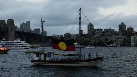 Passing boat in Sydney Harbour with Aboriginal flag 6K Stock Footage 330445250