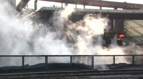 A passing car with a burning coal in the background, and the smoke in the front Stock Footage 56959703