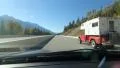 Passing classic red camper in the Rocky Mountains, BC, Canada. HD Footage
