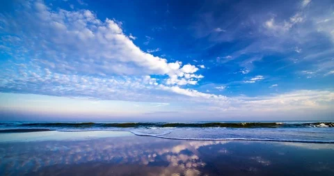 Passing cloud on blue sky over sea and sand beach with reflection when the su Stock Footage 98386971