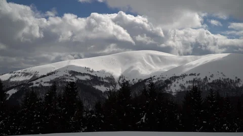 Passing Clouds Cast Shadows On Snow Capped carpathian mountains time lapse Stock Footage 87827381
