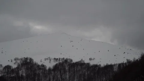 Passing Clouds Cast Shadows On Snow Capped carpathian mountains time lapse Stock Footage 87827517
