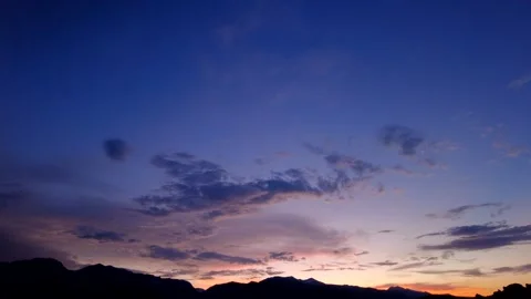 Passing clouds light up at sunset over the Sierra Mountains and Yosemite NP Video stock 166416644