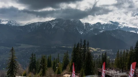 Passing clouds over the valley against the background of snowy mountains. Stock Footage 125829284