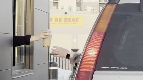 Passing coffee to customer at drive-through window 库存影片 238685817