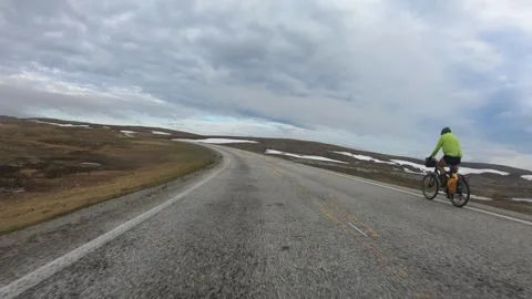 Passing a cyclist while driving on the road to North Cape in Norway. Stock Footage 251419430