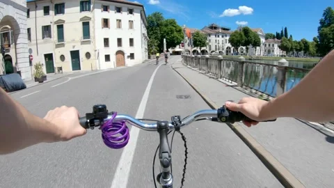 Passing the Dante bridge in Treviso next to Sile river city bike pov Stock Footage