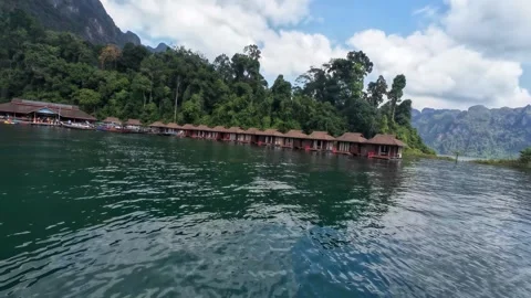 Passing Floating Bungalows on Cheow Lan Lake Stock Footage 329073744