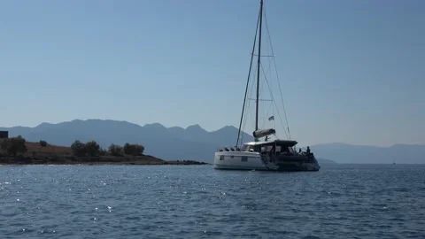 Passing by a floating catamaran 스톡 동영상 218254793
