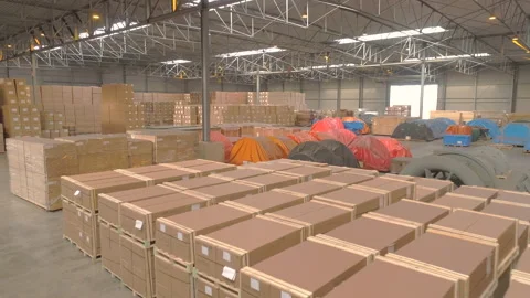 Passing forklift flying into warehouse packed with breakbulk and boxes Stock Footage 140811261