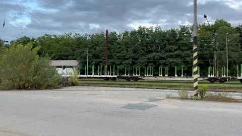 Passing freight train at small railway station on the outskirts of Brno Stock Footage 263961815
