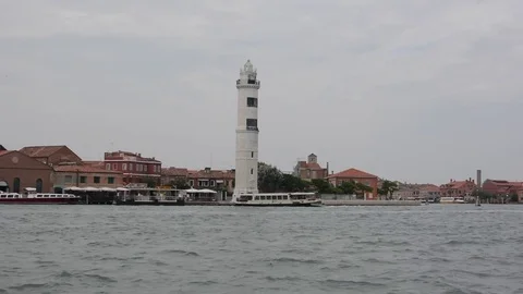 Passing a lighthouse on a ferry boat that is going from Murano to Venice Stock Footage 72975292