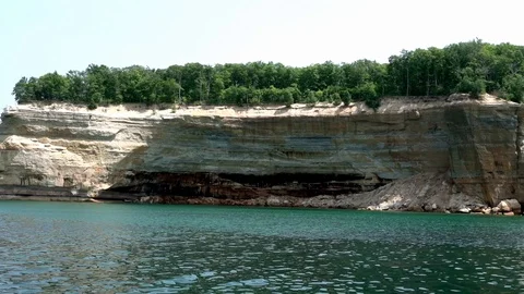 Passing the limestone cliffs of Pictured Rocks National Lakshore, munising MI Stock Footage 125054666
