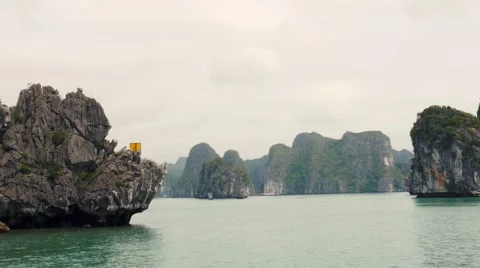Passing by the limestone rocks of Ha Long Bay, Vietnam. Tracking shot Stock Footage 65508562
