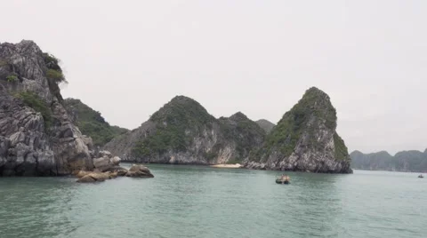 Passing by the limestone rocks of Ha Long Bay, Vietnam. Tracking shot Stock Footage 65508655