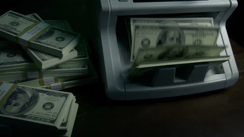 Passing A Money Counter Machine As It Counts Dollars Video stock 137265986
