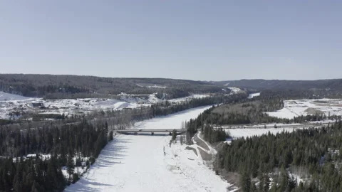 Passing over Concrete Bridge Over A Small frozen River in winter Stock Footage 145964116
