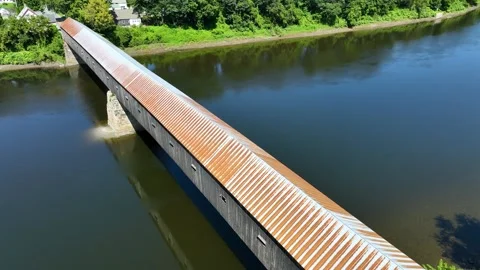 Passing over the Cornish Windsor covered bridge spanning the Connecticut River. Video stock 269979017