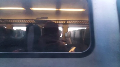 Passing passenger train shows people inside 1 Stock Footage 122967598