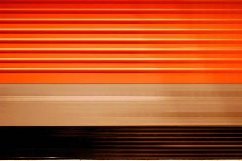 Passing red train with motion blur and a striped pattern passing red train... Foto stock