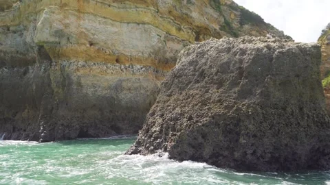 Passing a rock in the ocean with big waves and cliffs from Portugal Video stock 273674787