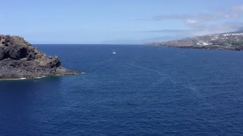Passing by the Roque de Garachico. Big rock on the water. Drone. Aerial. Video stock 210480299