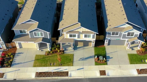 Passing by a row of newly constructed homes for sale, aerial view looking down Stock Footage 160170754