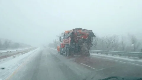 Passing a Snow Plow on Freeway in a Blizzard Stock Footage 84154413