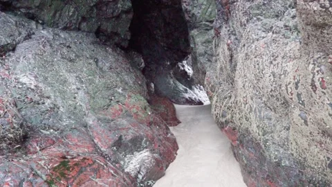 Passing Through A Beach Cave Tunnel Stockbeeldmateriaal 153313217