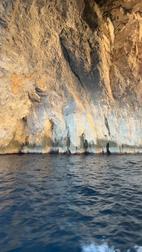 Passing through the Blue Grotto arched rock formation on Malta's south coast. Stock Footage 296681622