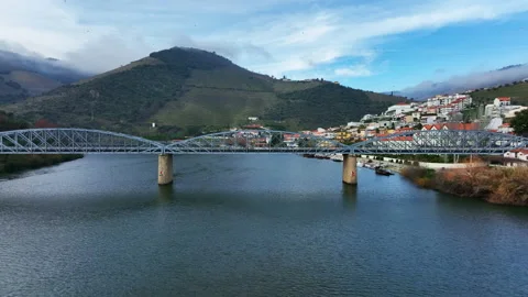 Passing through a bridge Drone shot of Régua in Douro River, Portugal Stock Footage 188505664