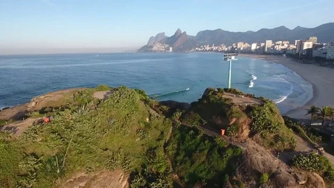 Passing through the rocks and arriving at swimmers and surfers. Stock Footage 81132971