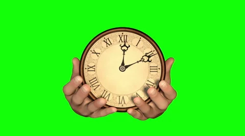 Passing of time. Hands holding fast turning clock. Green screen version. Stock Footage 44565909