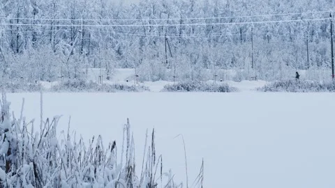 Passing Tractor and a Running Man in a Park in Winter Stock Footage 289892144